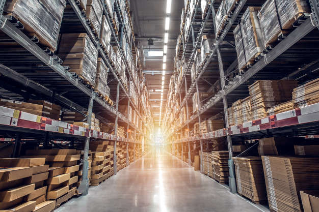 Rows of shelves with goods boxes in modern industry warehouse store at factory warehouse.
