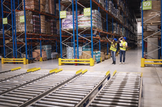 "Warehouse workers checking inventory and goods distribution in large storehouse Free Photo"