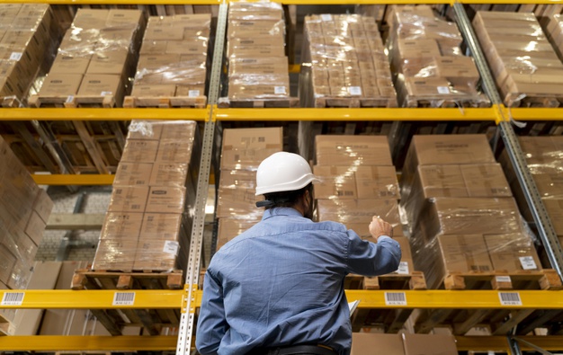 "Man with helmet working in warehouse Free Photo"